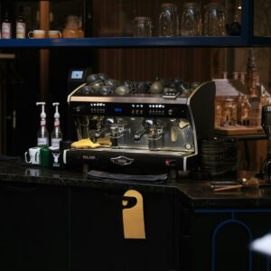 Espresso machine on a cafe counter with syrups